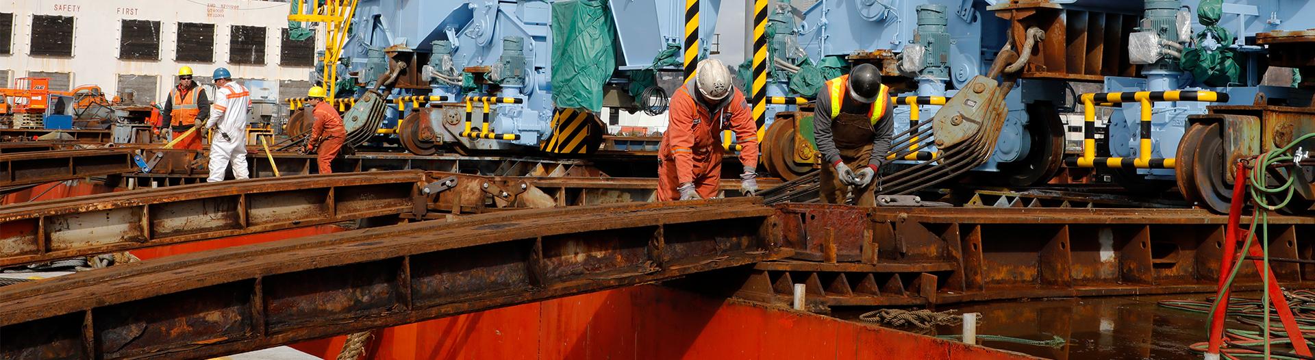photo of men working on a gantry crane