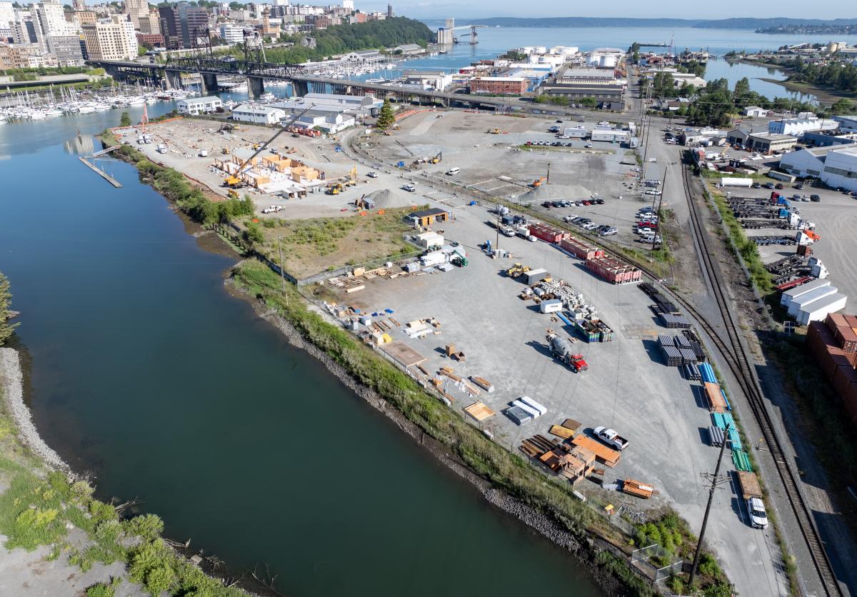 Drone shot of a waterway next to a parking lot.